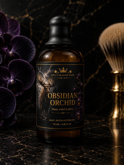 A 100 ml amber glass bottle of First Canadian Shave Obsidian Orchid after shave, styled on a black marble surface with purple orchids and a gold shaving brush.